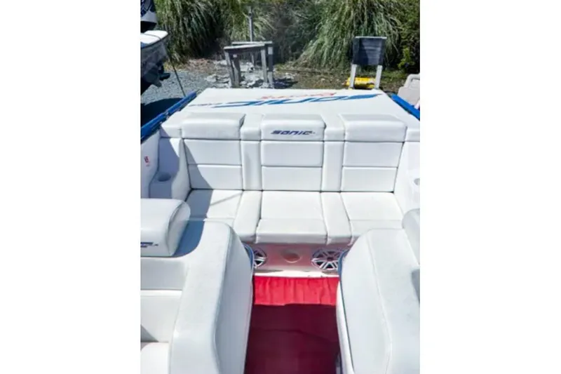 Slide: The Image of 2001 Sonic 31 SS boat interior with white seating and red carpet. - 4