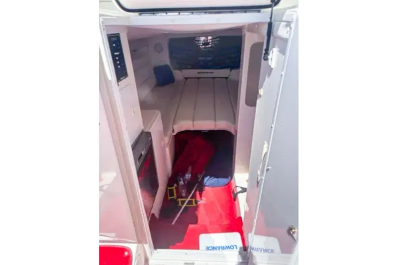 Slide: The Image of 2001 Sonic 31 SS boat cabin interior with seating and storage. - 7