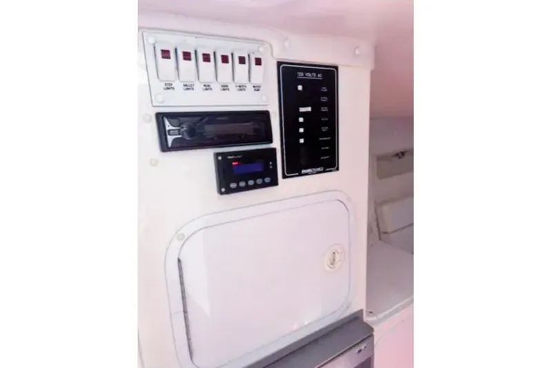 Slide: The Image of Control panel of a 2001 Sonic 31 SS boat with switches and display. - 8