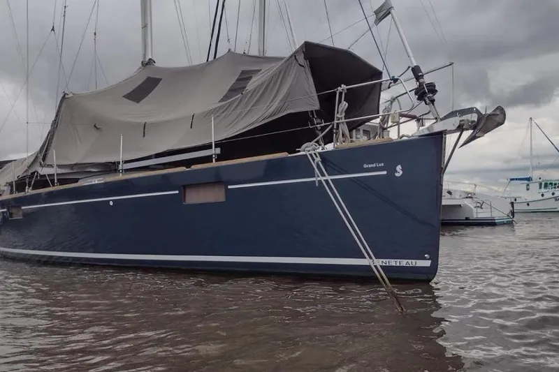 Slide: The Image of 2015 Beneteau Sense 55 yacht docked with mountain and buildings in background. - 11