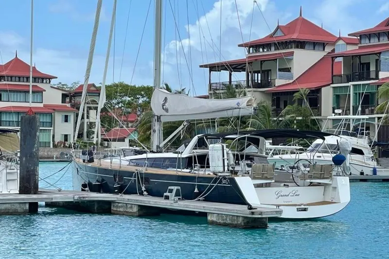 Slide: The Image of Bow view of 2015 Beneteau Sense 55 yacht on calm waters under blue sky. - 14