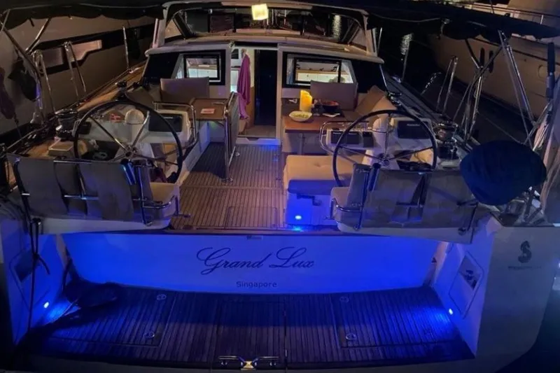 Slide: The Image of 2015 Beneteau Sense 55 yacht on calm waters, showcasing sleek deck design. - 15
