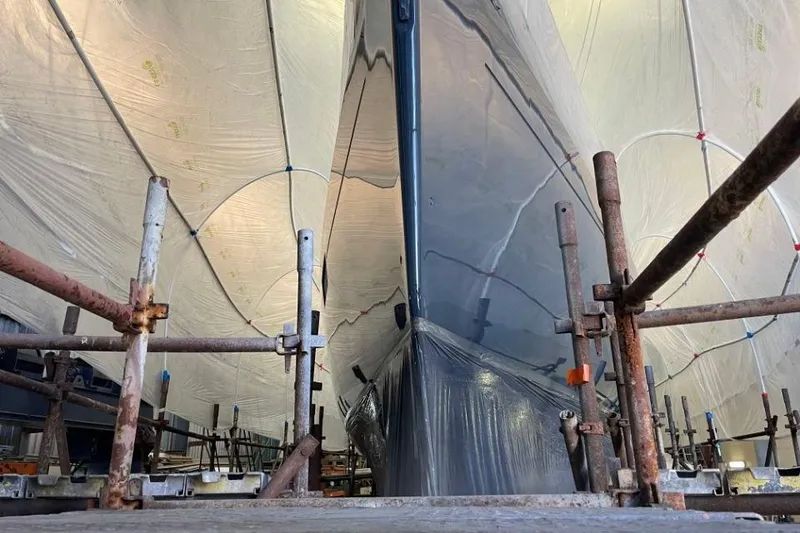 Slide: The Image of 2015 Beneteau Sense 55 sailboat on water, wooden deck, city skyline in background. - 18