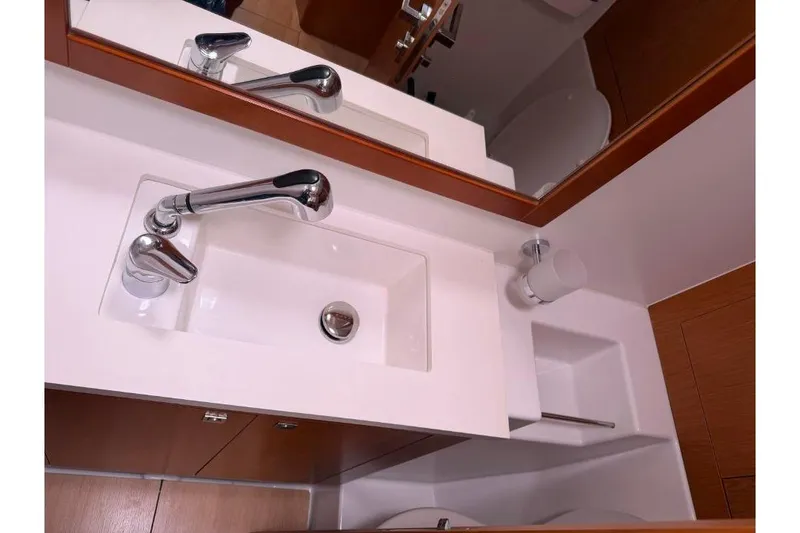 Slide: The Image of Luxurious 2015 Beneteau Sense 55 yacht with illuminated deck and elegant seating area. - 25