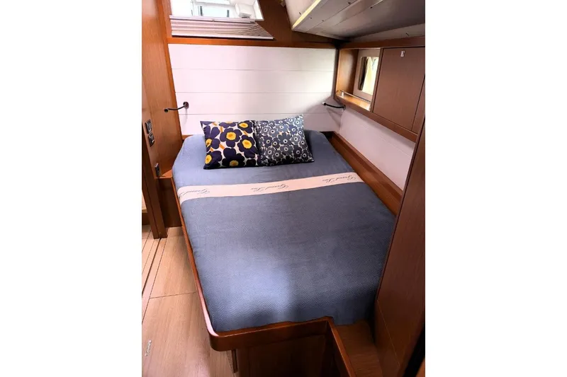 Slide: The Image of 2015 Beneteau Sense 55 sailboat on stands, covered, with trees in the background. - 27