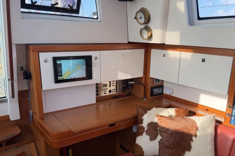 Slide: The Image of Interior of 2015 Beneteau Sense 55 yacht showing wooden cabinetry and closet space. - 35