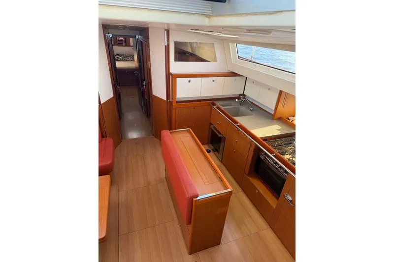 Slide: The Image of Bathroom interior of 2015 Beneteau Sense 55 yacht with modern sink and wooden cabinetry. - 36
