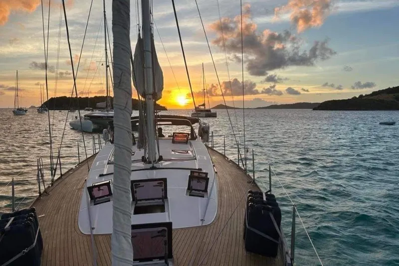 Slide: The Image of Sailing yacht Beneteau Sense 55, 2015 model, at sunset on tranquil waters. - 5