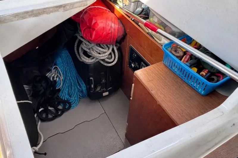 Slide: The Image of Storage compartment on a 2015 Beneteau Sense 55 yacht with ropes and tools. - 61