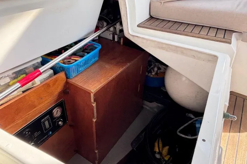 Slide: The Image of Storage compartment on a 2015 Beneteau Sense 55 yacht, featuring tools and equipment. - 62