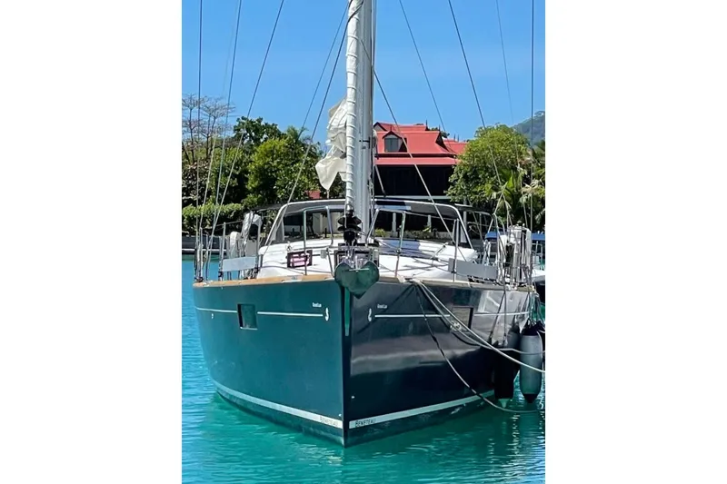 Slide: The Image of Beneteau Sense 55 yacht docked at marina, surrounded by modern buildings, 2015 model. - 8