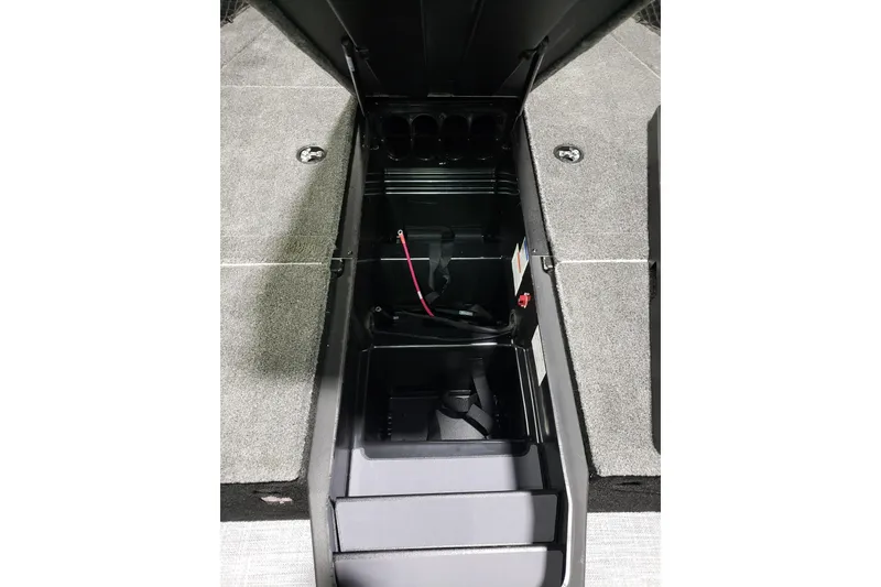 Slide: The Image of 2026 Alumacraft Competitor 185X Tiller boat storage compartment, open with visible wiring. - 15