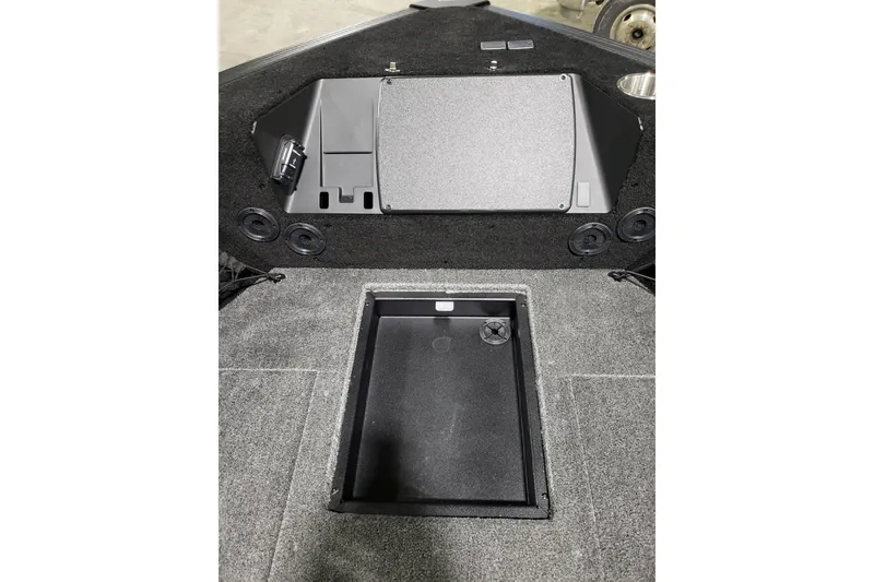 Slide: The Image of 2026 Alumacraft Competitor 185X Tiller boat interior with storage compartment and control panel. - 17