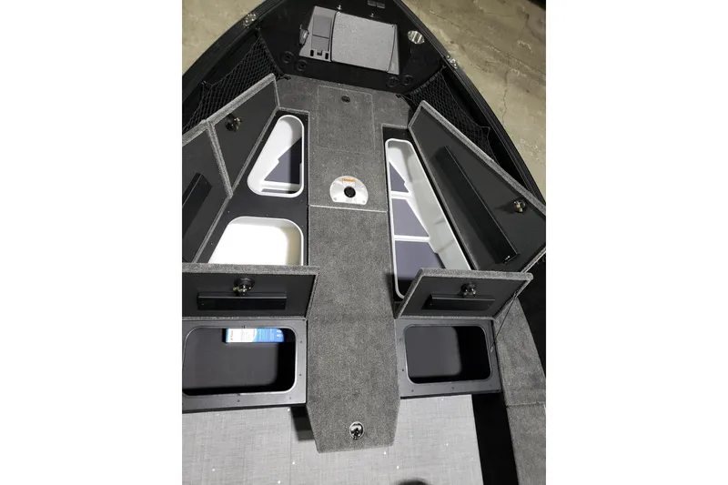 Slide: The Image of 2026 Alumacraft Competitor 185X Tiller boat interior with open storage compartments. - 6