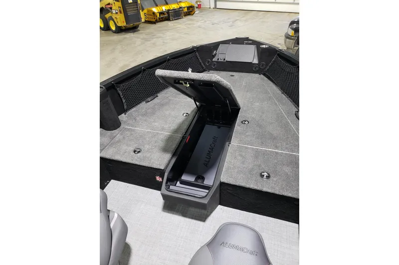 Slide: The Image of 2026 Alumacraft Competitor 185X Tiller boat interior with open storage compartment. - 7