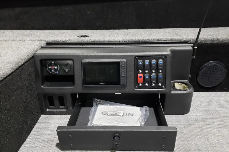 Slide: The Image of 2026 Alumacraft Competitor 185X Tiller dashboard with Garmin display and control panel. - 9