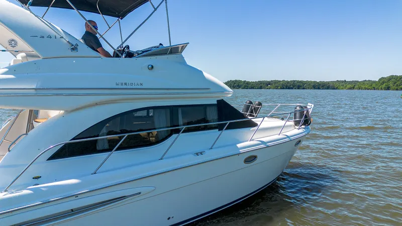 Slide: The Image of 2005 Meridian 341 Sedan on calm lake under clear sky. - 25