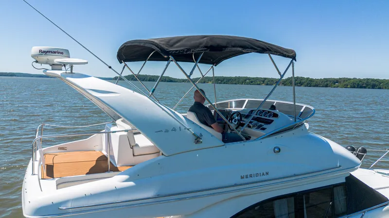 Slide: The Image of 2005 Meridian 341 Sedan on calm waters with captain at helm. - 26