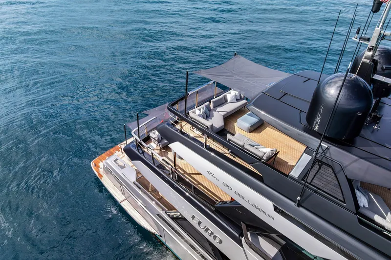 Slide: The Image of Luxurious 2024 Riva 130' Bellissima yacht with elegant deck and seating area on the water. - 8