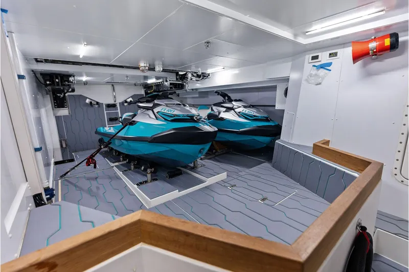Slide: The Image of Interior of 2024 Riva 130' Bellissima yacht with two blue jet skis. - 57