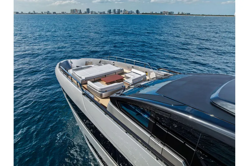 Slide: The Image of Luxurious 2024 Riva 130' Bellissima yacht cruising on open sea with city skyline. - 6