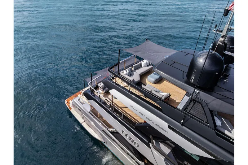 Slide: The Image of Luxurious 2024 Riva 130' Bellissima yacht with elegant deck and seating area on the ocean. - 8