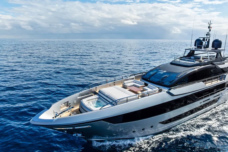 Slide: The Image of Luxury 2024 Riva 130' Bellissima yacht cruising on open sea under clear skies. - 3