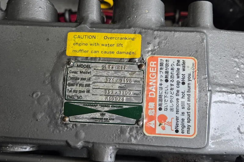 Slide: The Image of 2005 SeaVee 310i Open engine label with caution and danger warnings. - 12