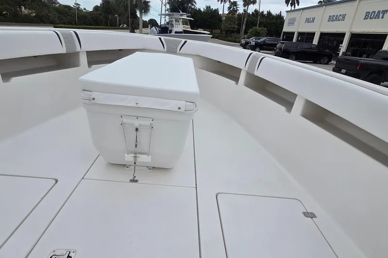 Slide: The Image of 2005 SeaVee 310i Open boat interior with seating and storage, docked near Palm Beach Boats. - 13