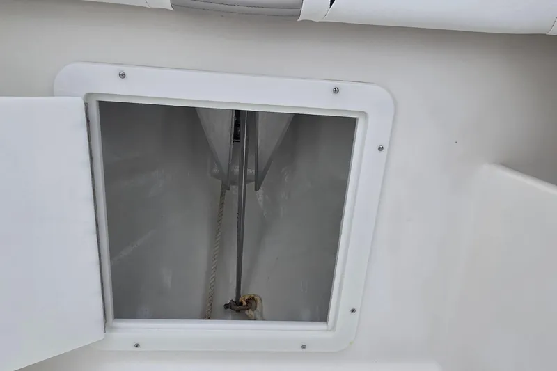 Slide: The Image of 2005 SeaVee 310i Open boat storage compartment with open hatch and visible rope. - 18