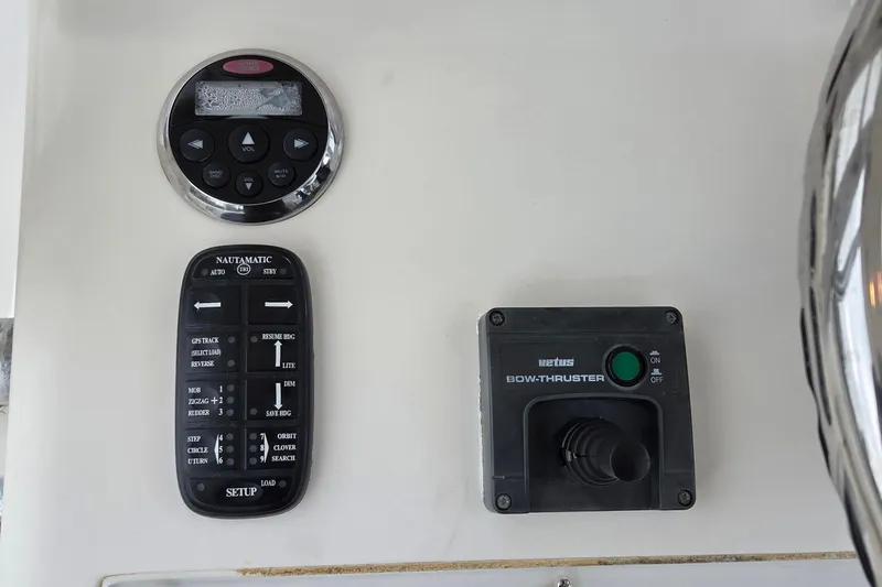 Slide: The Image of Control panel of a 2005 SeaVee 310i Open boat with bow thruster and audio controls. - 21