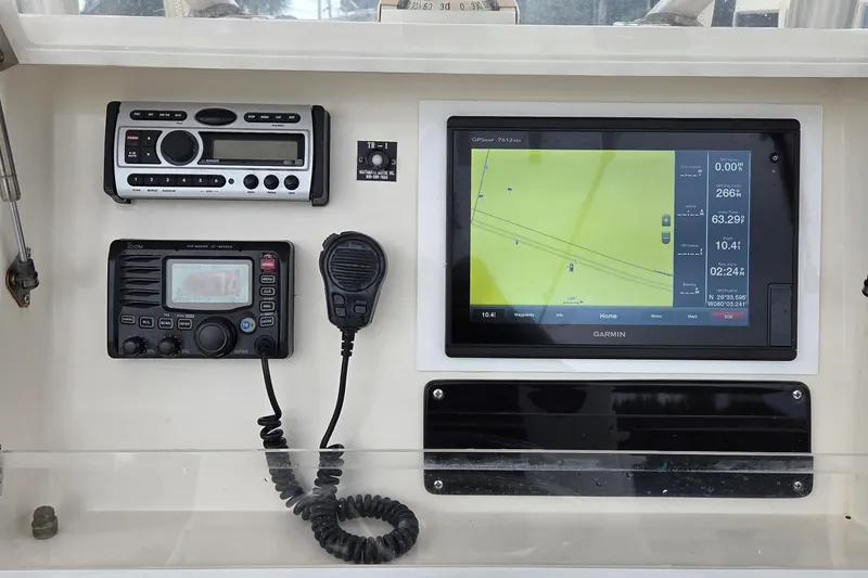 Slide: The Image of 2005 SeaVee 310i Open boat dashboard with Garmin GPS and marine radio equipment. - 22