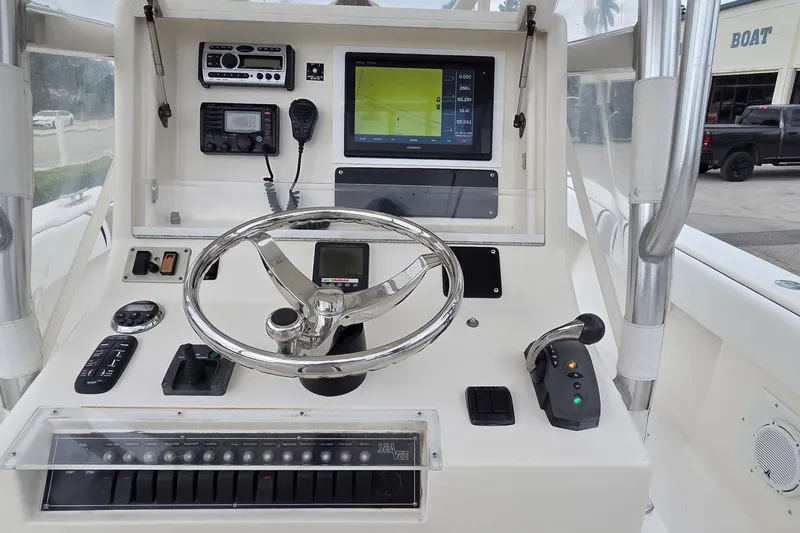 Slide: The Image of 2005 SeaVee 310i Open boat dashboard with steering wheel, controls, and navigation display. - 23