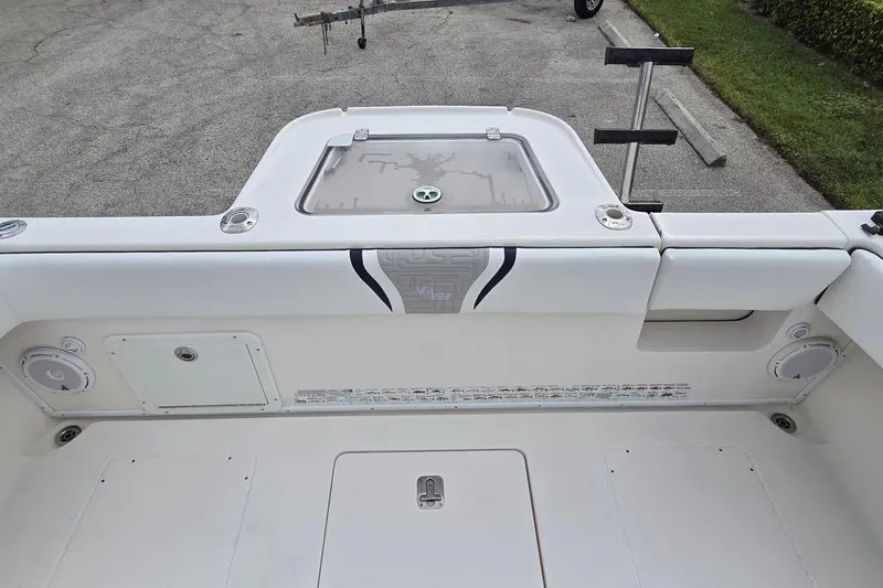 Slide: The Image of 2005 SeaVee 310i Open boat interior, featuring storage compartments and rod holders. - 27