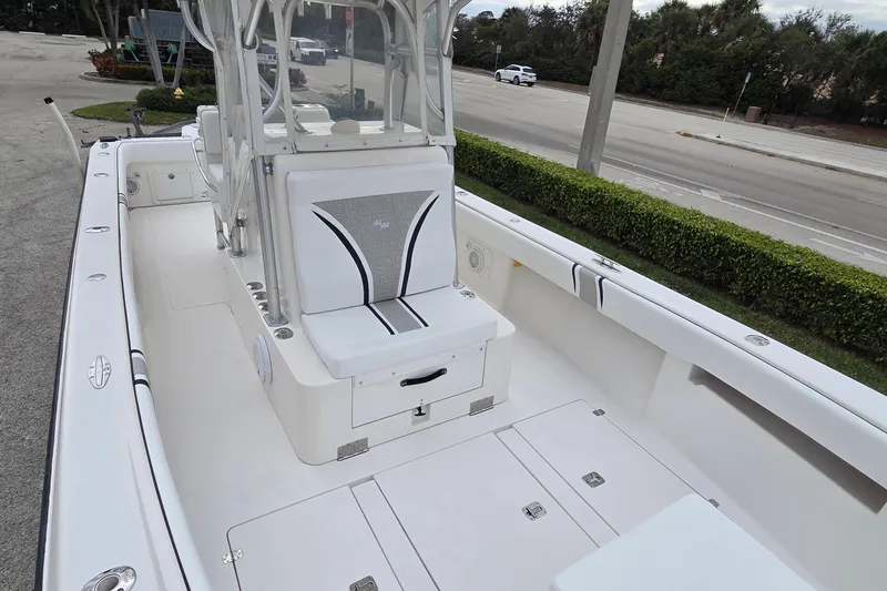 Slide: The Image of 2005 SeaVee 310i Open boat interior with seating and console, parked near a road. - 32
