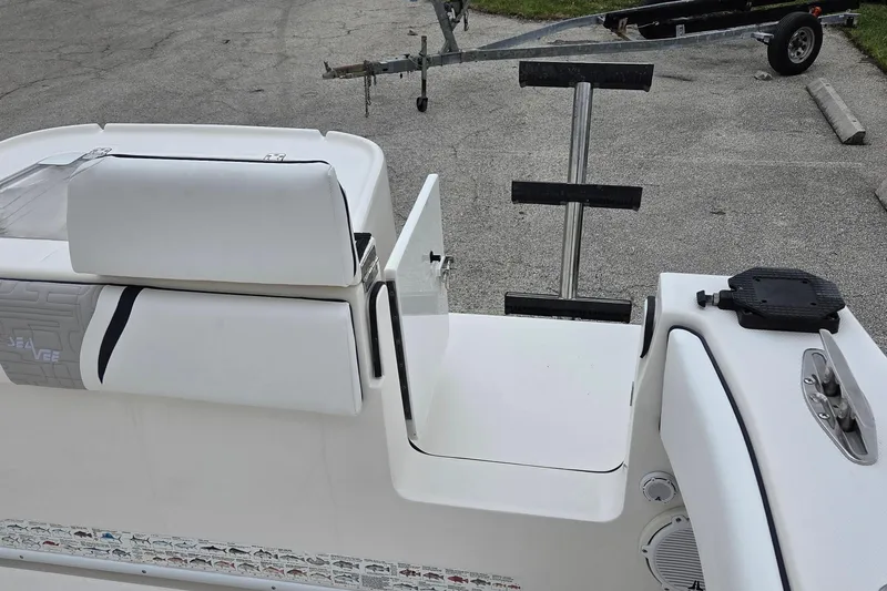 Slide: The Image of 2005 SeaVee 310i Open boat interior with seating and ladder, parked on pavement. - 36