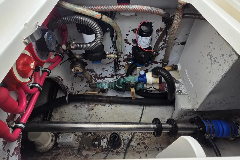 Slide: The Image of 2005 SeaVee 310i Open engine compartment with visible hoses and mechanical components. - 38