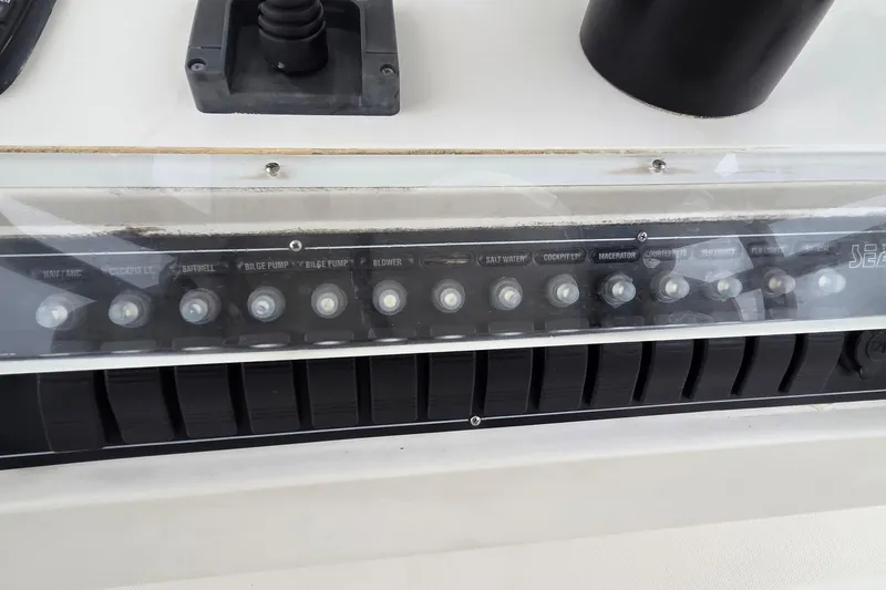 Slide: The Image of Control panel of a 2005 SeaVee 310i Open boat with labeled switches. - 39
