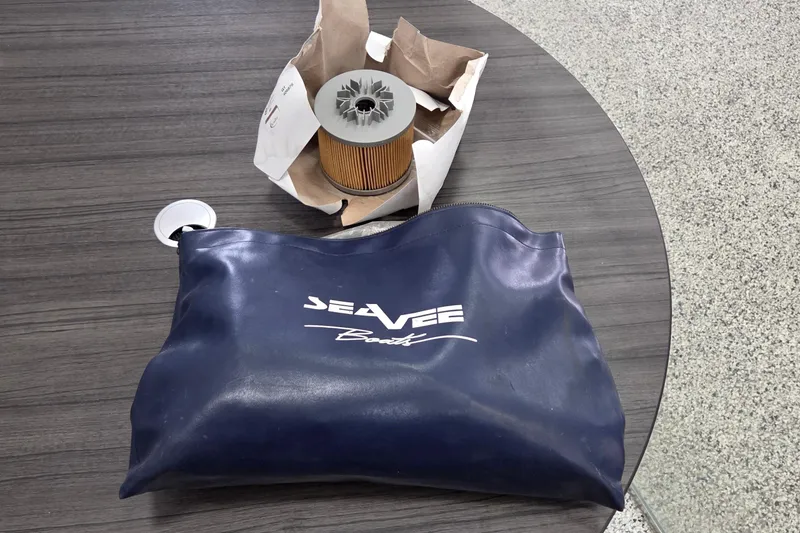 Slide: The Image of Blue SeaVee Boats bag and filter on a wooden table, 2005 SeaVee 310i Open. - 44