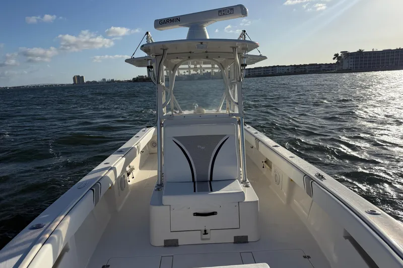 Slide: The Image of 2005 SeaVee 310i Open boat on water, featuring Garmin equipment, under sunny skies. - 45