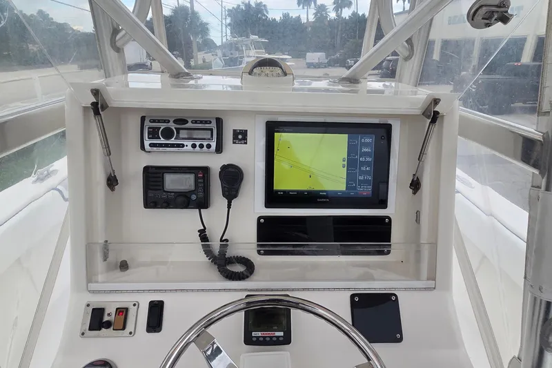 Slide: The Image of 2005 SeaVee 310i Open boat dashboard with navigation and communication equipment. - 6
