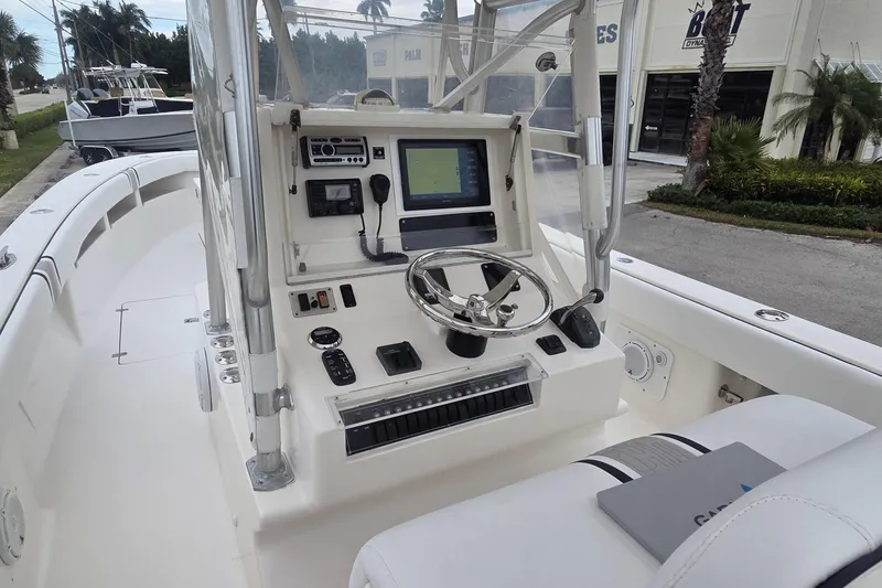 Slide: The Image of 2005 SeaVee 310i Open boat console with steering wheel and navigation equipment. - 7