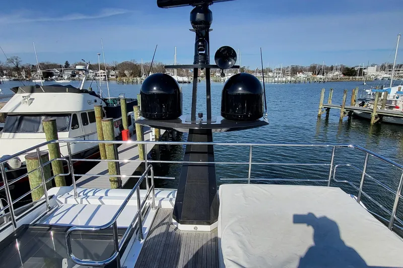 Slide: The Image of 2023 Azimut S7 yacht docked at marina, showcasing upper deck and radar equipment. - 12
