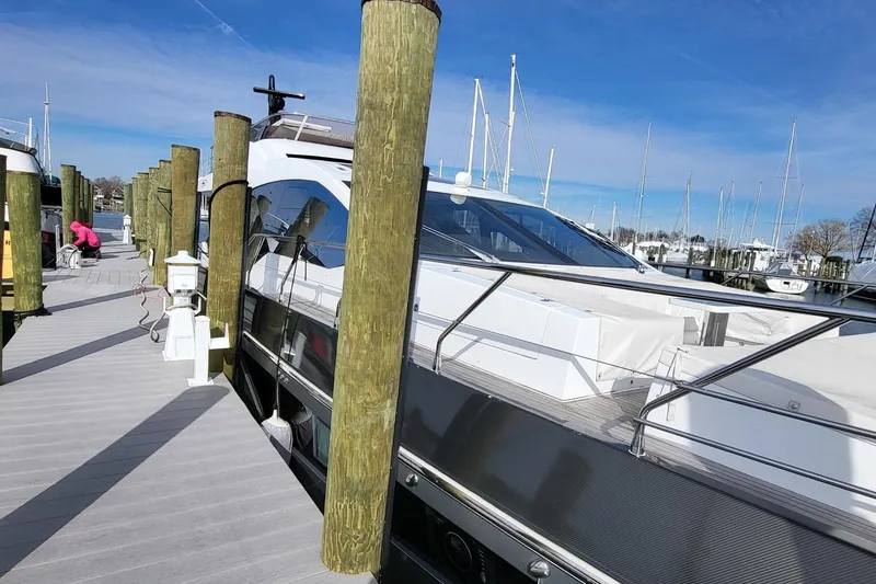 Slide: The Image of 2023 Azimut S7 yacht docked at marina under clear blue sky. - 16
