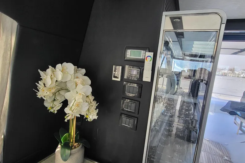 Slide: The Image of 2023 Azimut S7 yacht interior with elegant white orchids and modern control panel. - 19