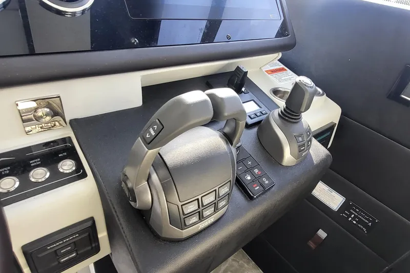 Slide: The Image of Control panel of 2023 Azimut S7 yacht with joystick and throttle levers. - 25