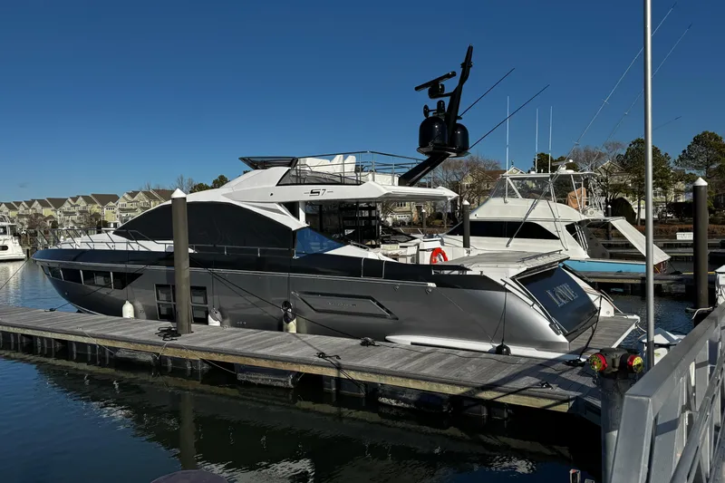 Slide: The Image of 2023 Azimut S7 luxury yacht docked at a marina under clear blue skies. - 3