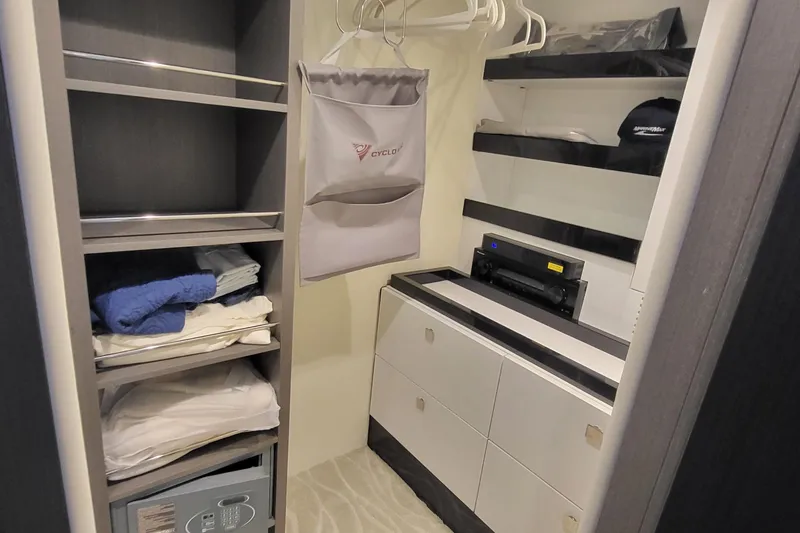 Slide: The Image of Luxury yacht Azimut S7 2023 interior closet with shelves, safe, and hanging space. - 32