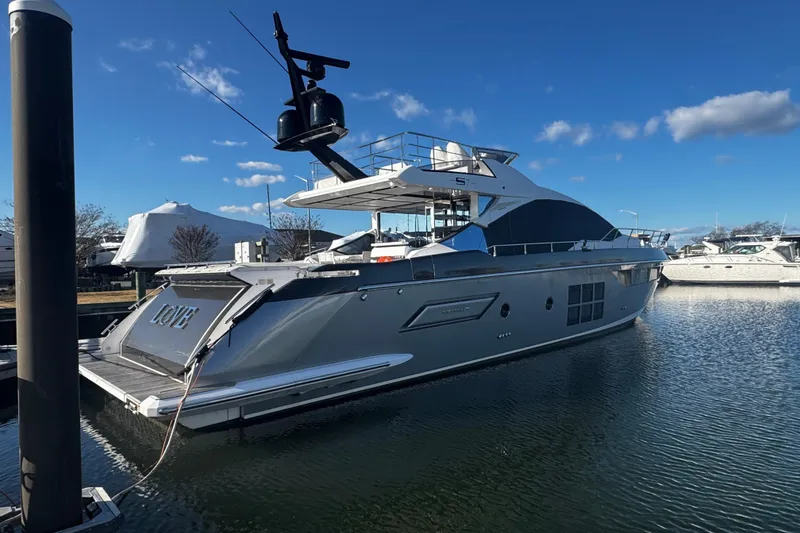 Slide: The Image of 2023 Azimut S7 luxury yacht docked in a marina under clear blue skies. - 6