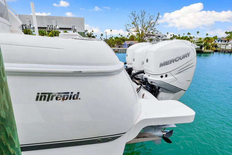 Slide: The Image of 2019 Intrepid 410 Evolution boat with Mercury engines docked in a tropical marina. - 21